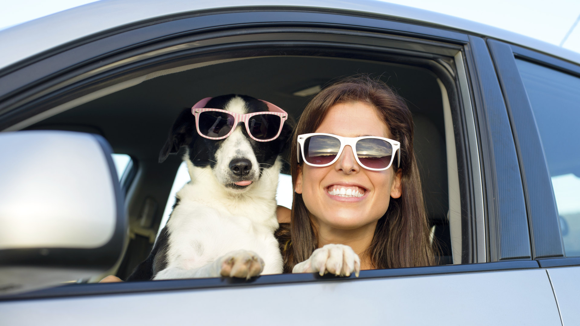 Woman and dog wearing sunglasses